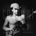 Steve Ray Vaughan (Unknown date)

[keywords]Black & white image, musician, hat, guitar, tattoo[/keywords]